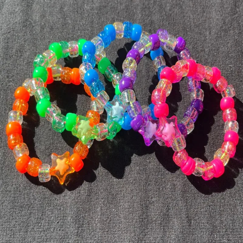 Three neon kandi star bead bracelets laid flat