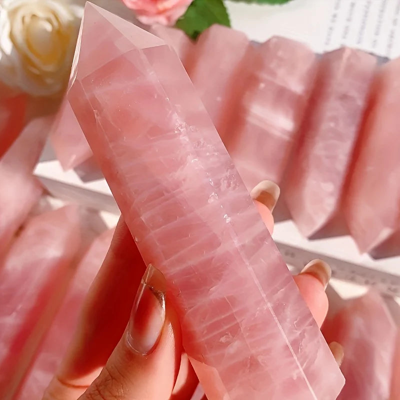 Rose quartz point held in hand