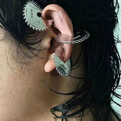 Buzzsaw cyber drop earring stacked on ear