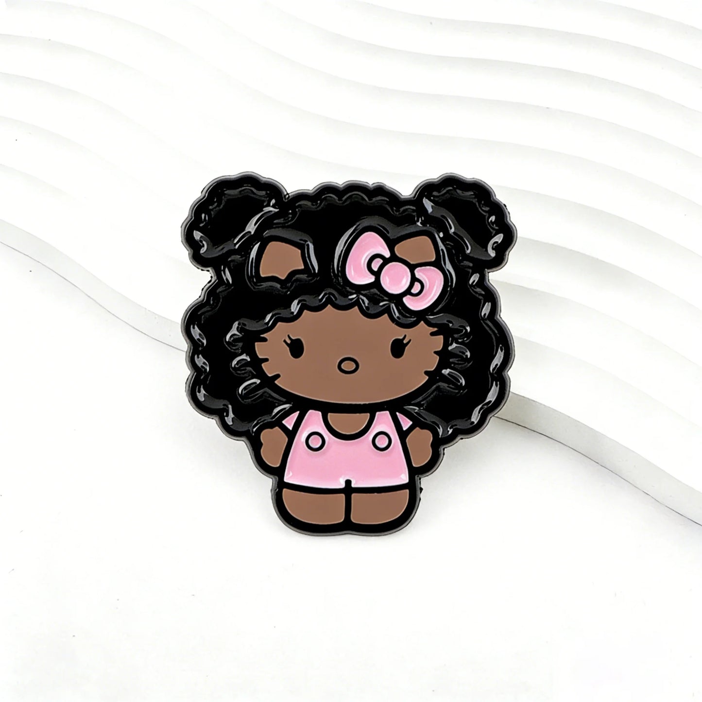 Kawaii kitty enamel pin with black curly hair and pink bow