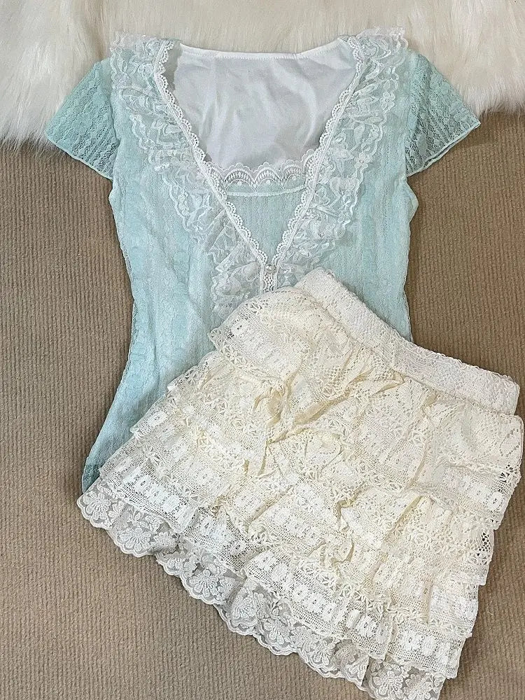 Ruffled lace top and cream lace tiered mini skirt laid flat
