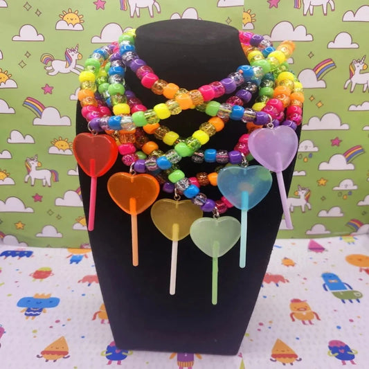 Sugar Crash kandi lollipop charm necklaces layered on a display bust