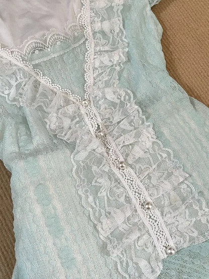 Close up of ruffled lace placket with pearl-look buttons