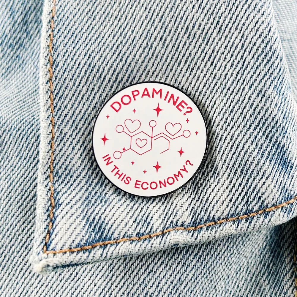 Enamel pin worn on a denim jacket pocket