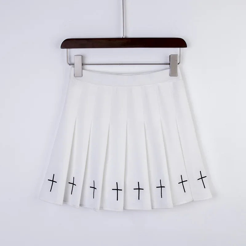 White pleated mini skirt with black embroidered crosses