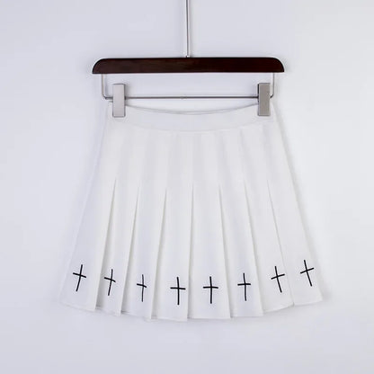White pleated mini skirt with black embroidered crosses