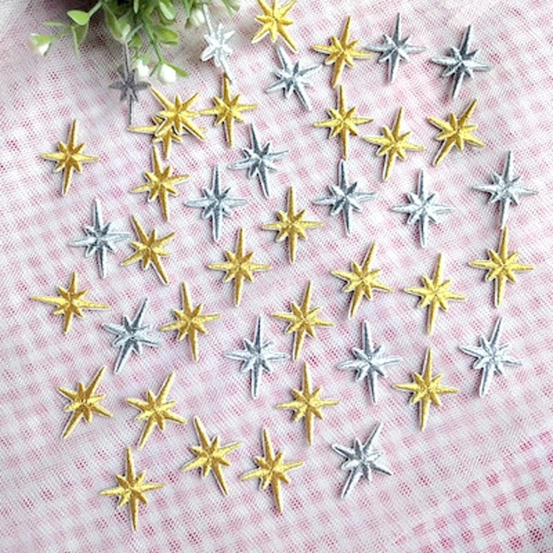 Gold and silver embroidered star patches spread out