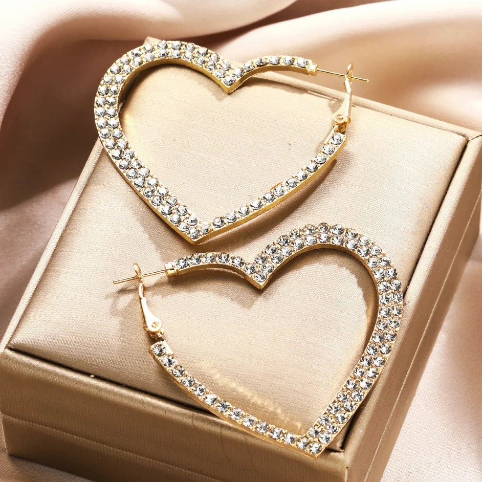 Gold tone crystal heart hoop earrings in a gift box