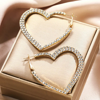Gold tone crystal heart hoop earrings in a gift box