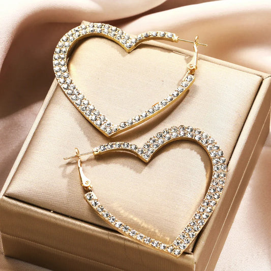 Gold tone crystal heart hoop earrings in a gift box