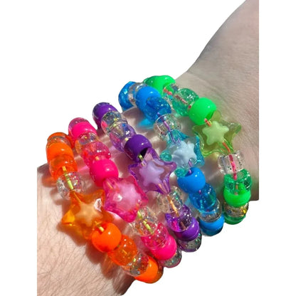 Close up of glitter clear and neon resin beads with star charms