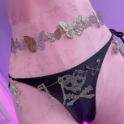 Close up of the rhinestone safety pin and cross detailing on the bottoms