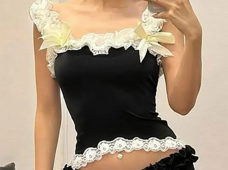 Black cami with ivory lace trim and pale yellow ribbon bows on the straps