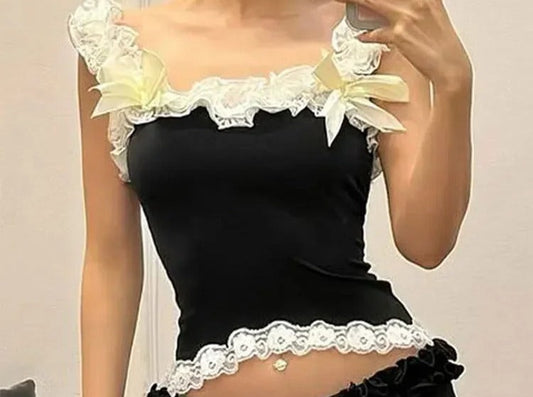 Black cami with ivory lace trim and pale yellow ribbon bows on the straps