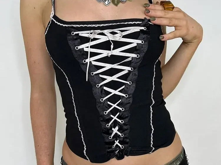 Black corset top with white grommet lace up panel and white ruffle trim