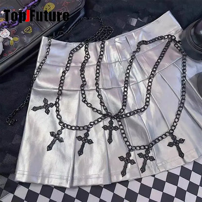 Cross chain belt laid over a pleated mini skirt