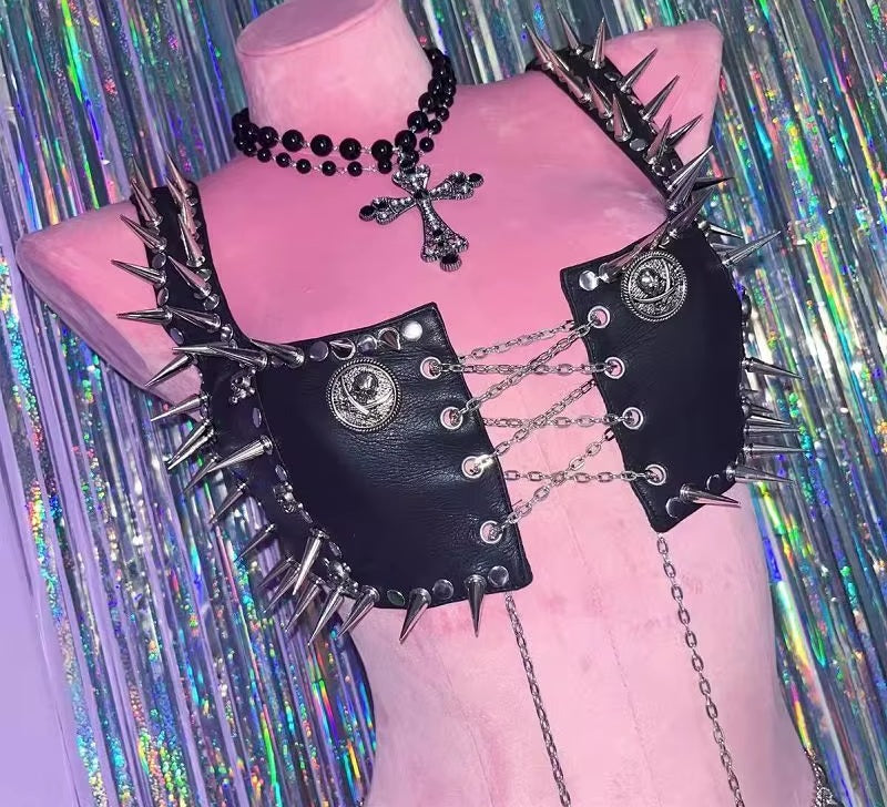 Spiked vegan leather crop harness on a display form