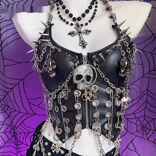 Front view of a black vegan leather corset top with silver-tone spikes, draped chain and skull medallion