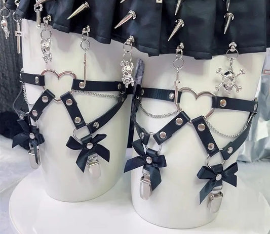 Black vegan leather chained thigh garters with bows, heart O-ring and metal clips, worn