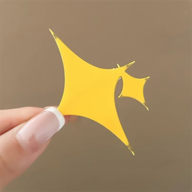 Close up of the glossy yellow sparkle clip held in hand