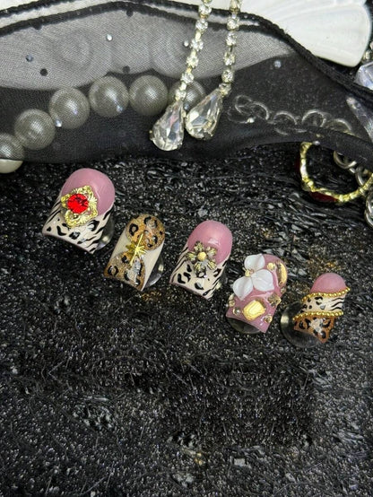 Champagne Safari press-on nails, five nail row with red gem and floral accents