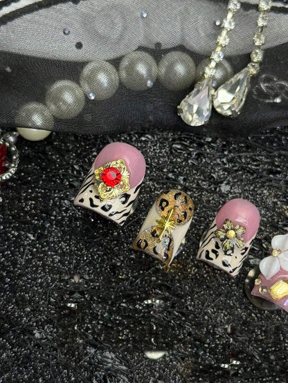 Champagne Safari press-on nails, close detail of the gold starburst charm