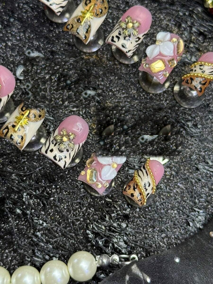 Champagne Safari press-on nails, overhead detail of the pearl flower accent nail
