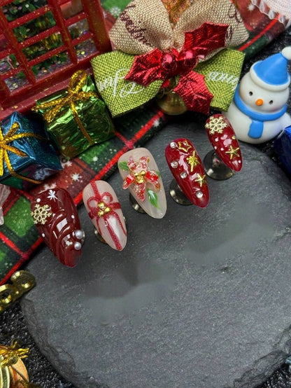 Close detail of the snowflake and ribbon bow nail art