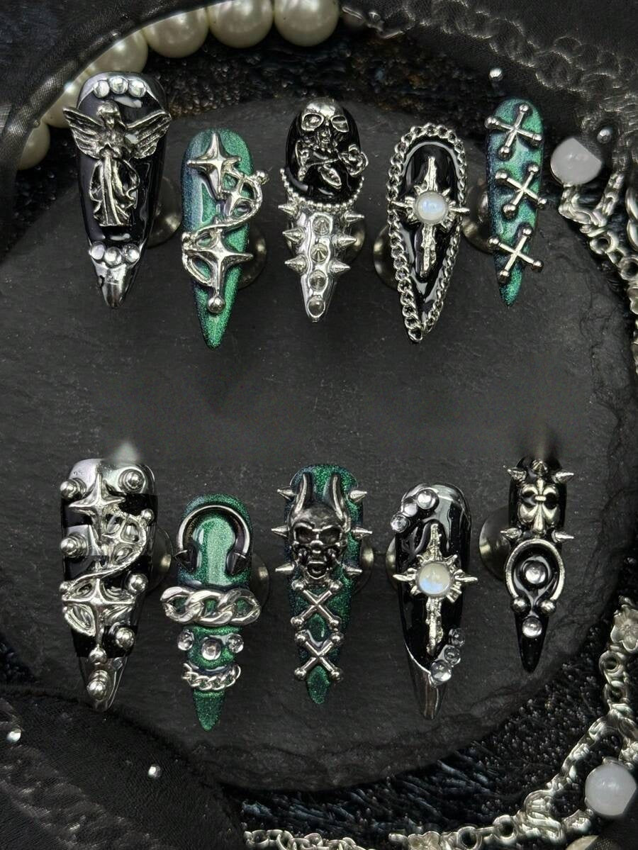Full ten piece long stiletto press-on nail set in black and chrome jade with silver crosses and skulls