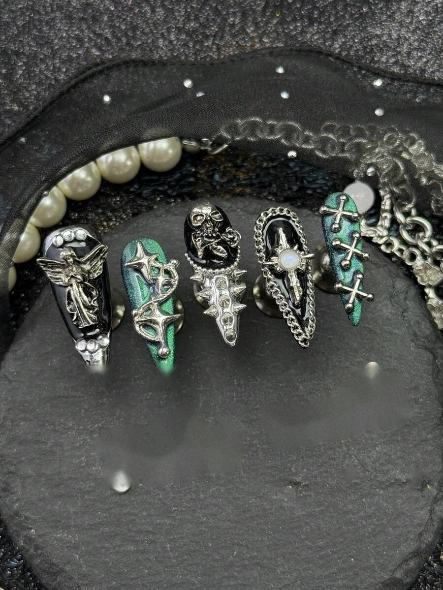 Detail of the silver angel, spike and chain nail hardware