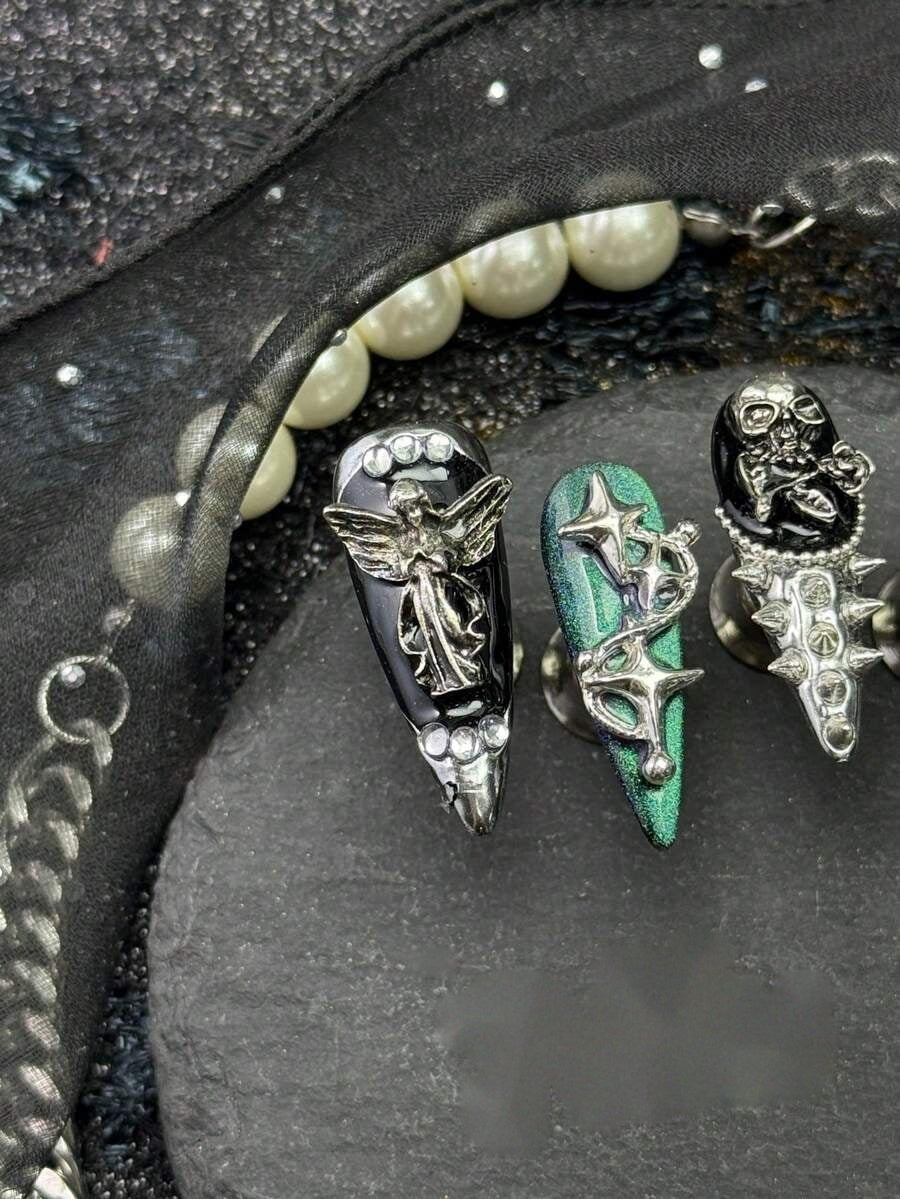 Close view of the black lacquer and jade chrome stiletto tips