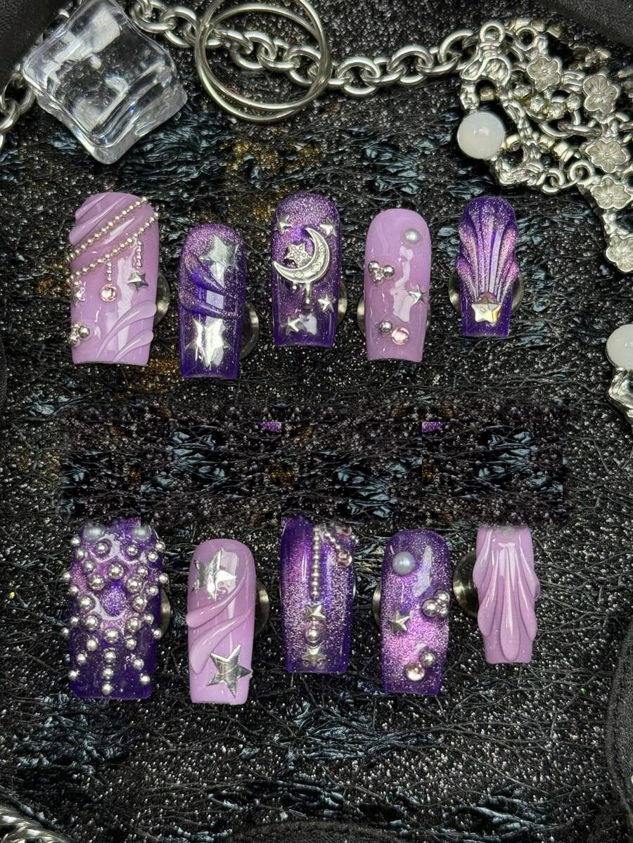 Full ten piece set of violet cat-eye square press-on nails with silver moons and stars