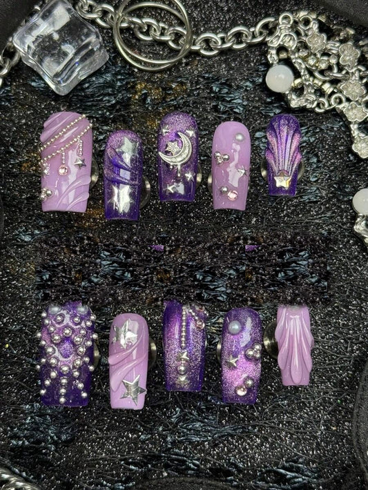 Full ten piece set of violet cat-eye square press-on nails with silver moons and stars