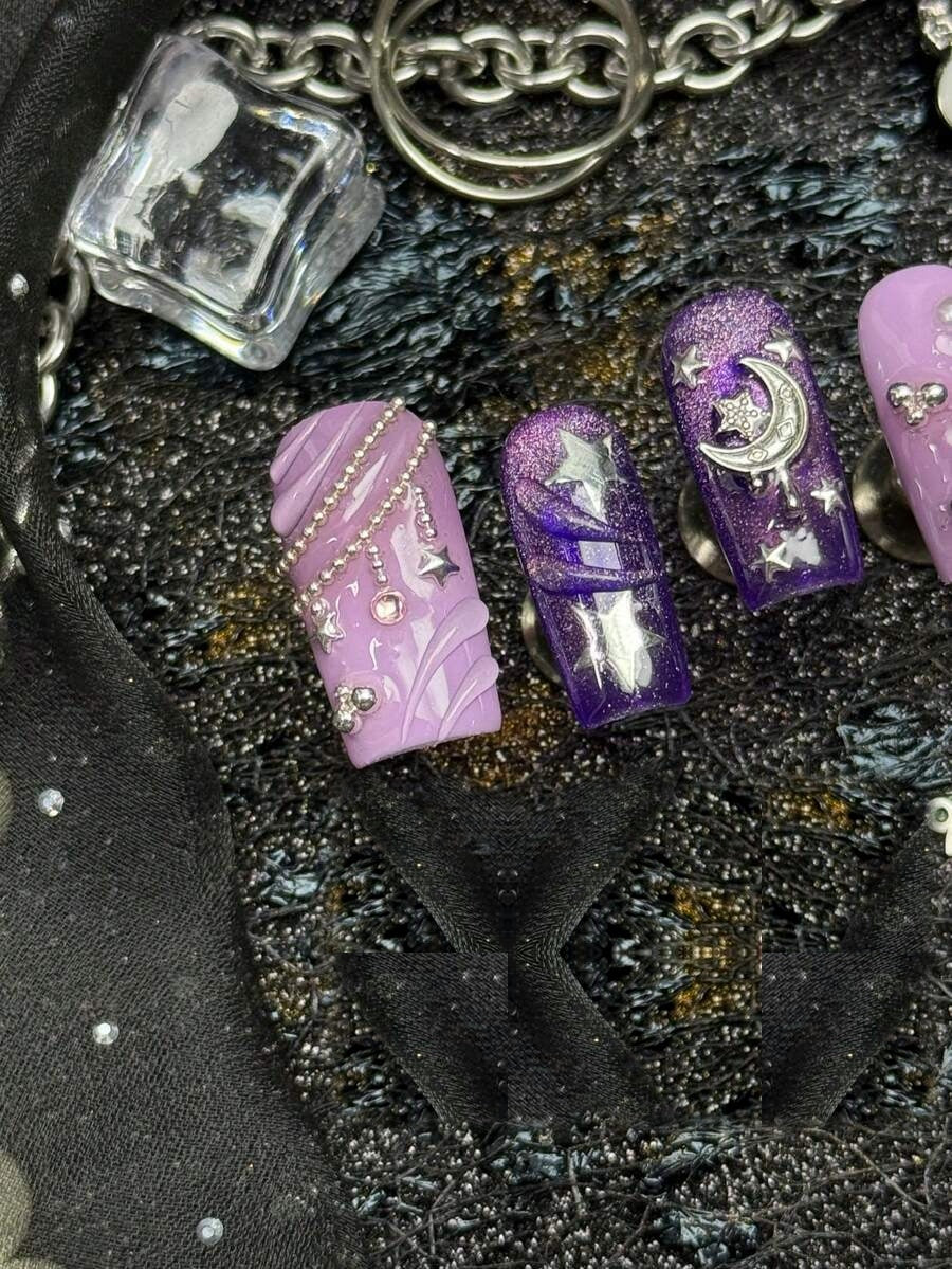Detail of the lilac marbled and deep purple glitter nails