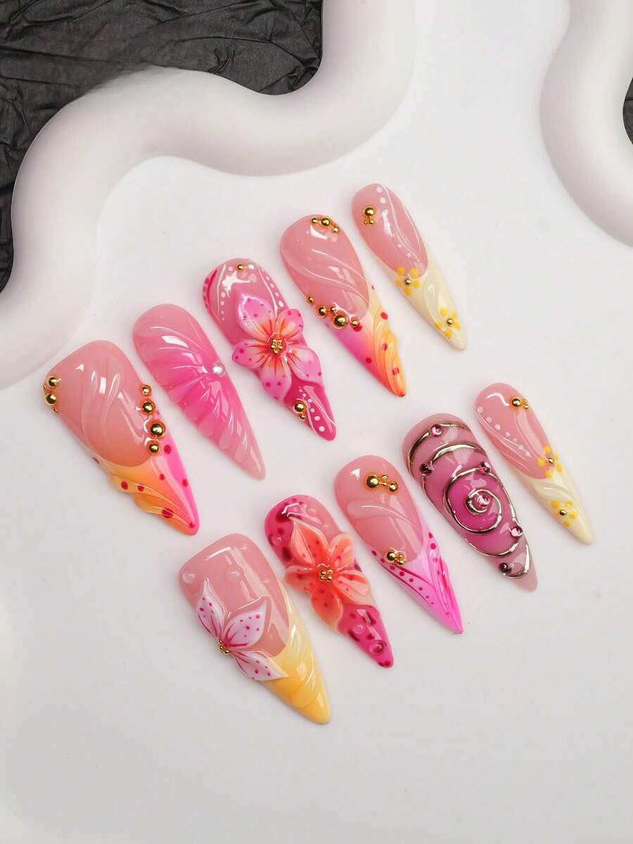 Full set of sunset lily press-on nails laid out by finger