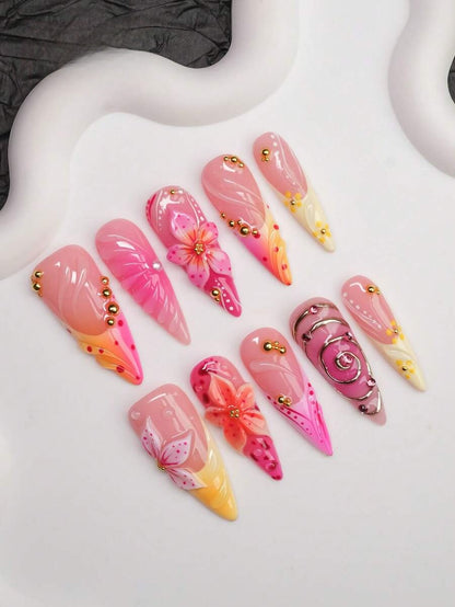 Full set of sunset lily press-on nails laid out by finger