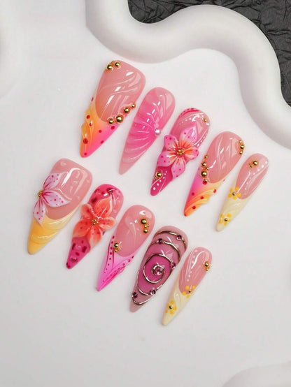 Close view of the 3D lily, gold bead and chrome swirl detail on the sunset nails