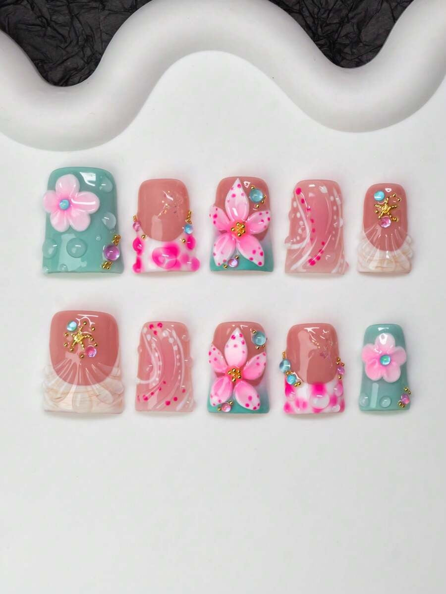 Full set of tidepool flower duck press-on nails laid out by finger