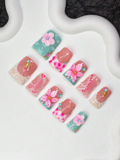 Close view of the tie-dye French tips, shells and crystals on short duck nails
