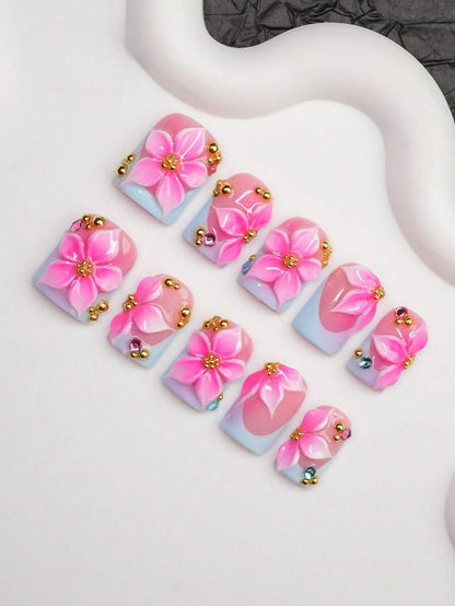 Close view of the 3D hibiscus, gold bead and crystal detail on short square nails