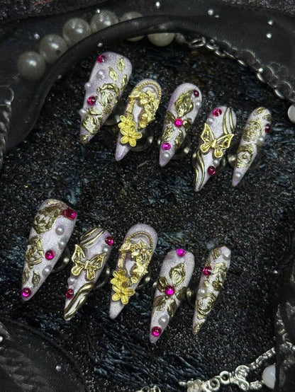 Gold floral, pearl and pink crystal detail on lilac stiletto nails