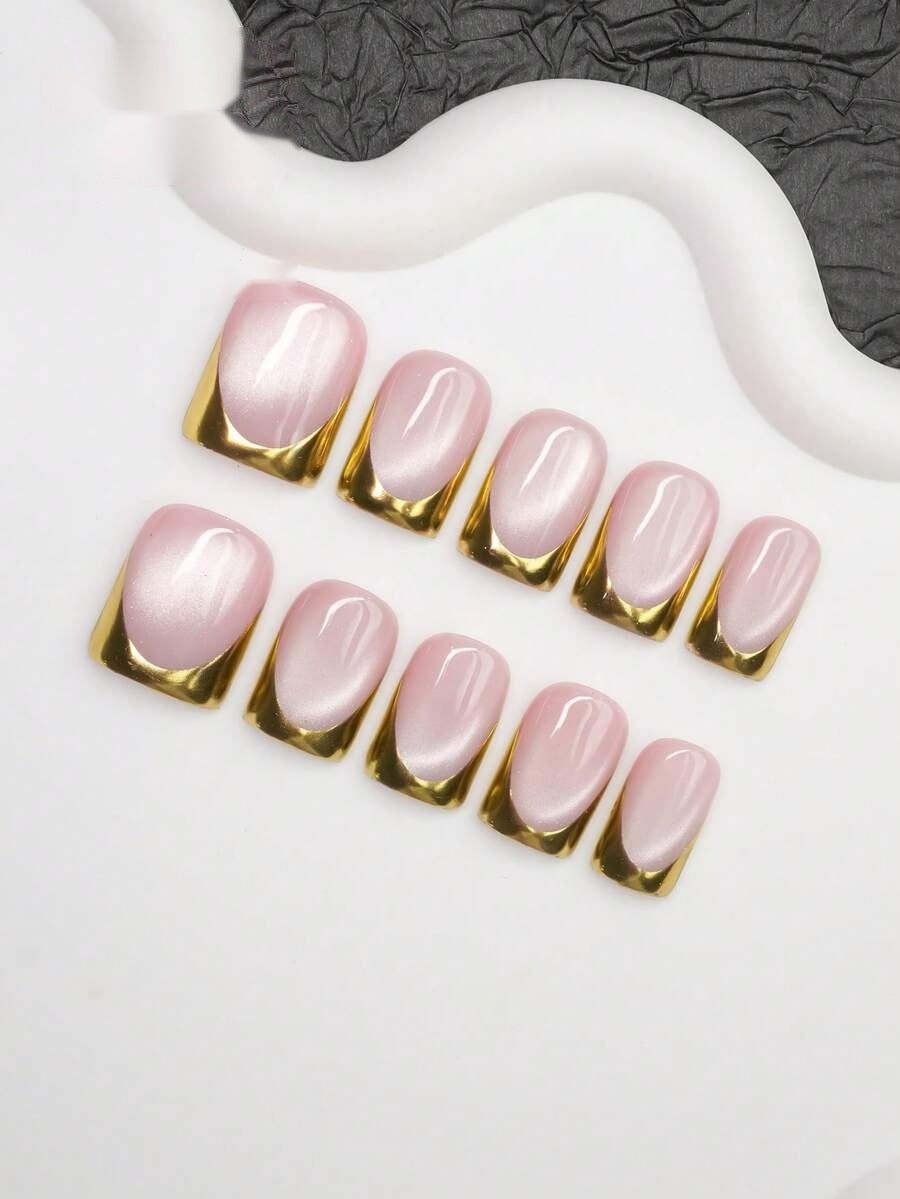 Pink cat-eye gold tip short square press-on nails flat lay