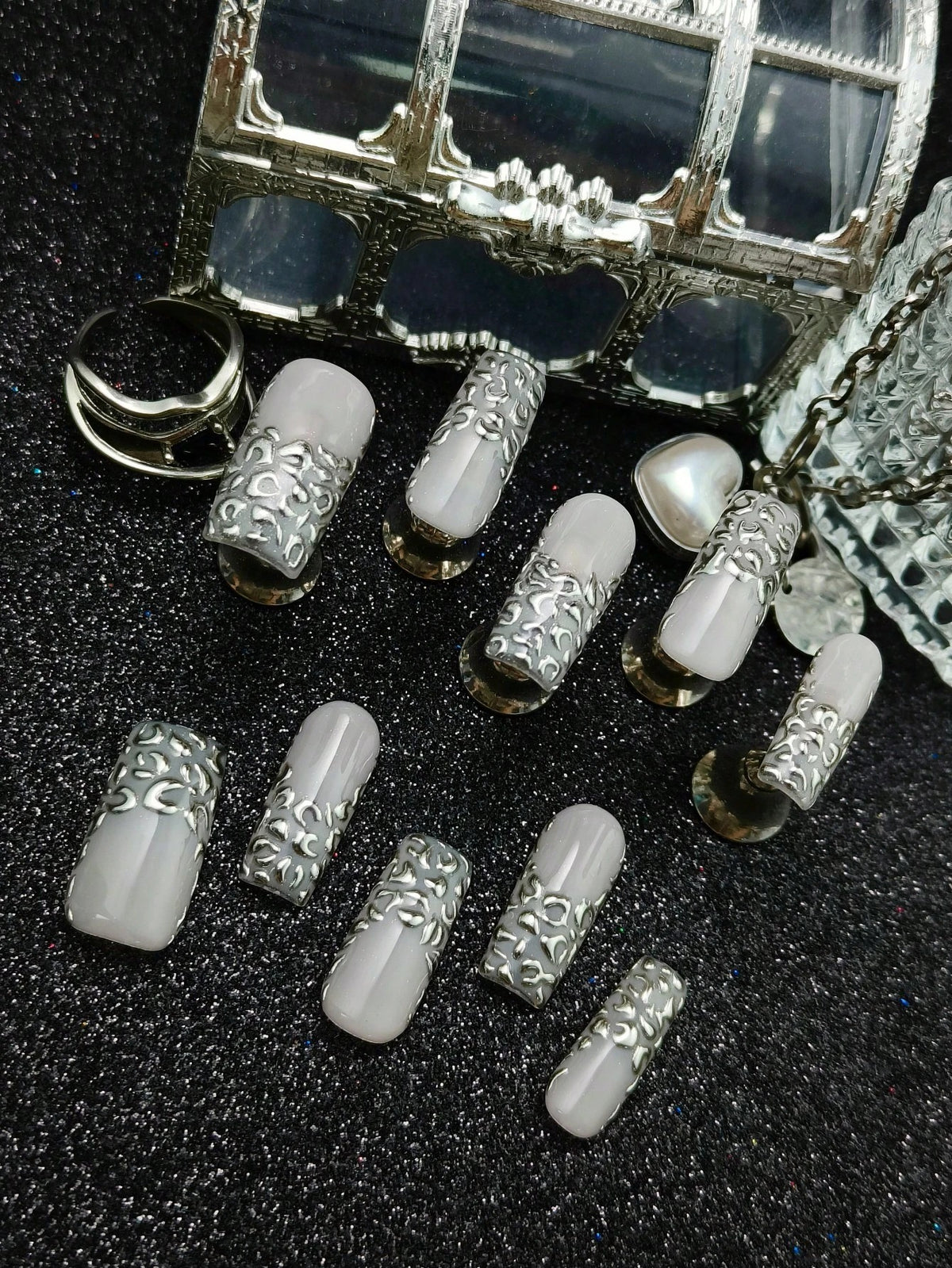 Liquid Leopard press on nails styled with silver jewelry