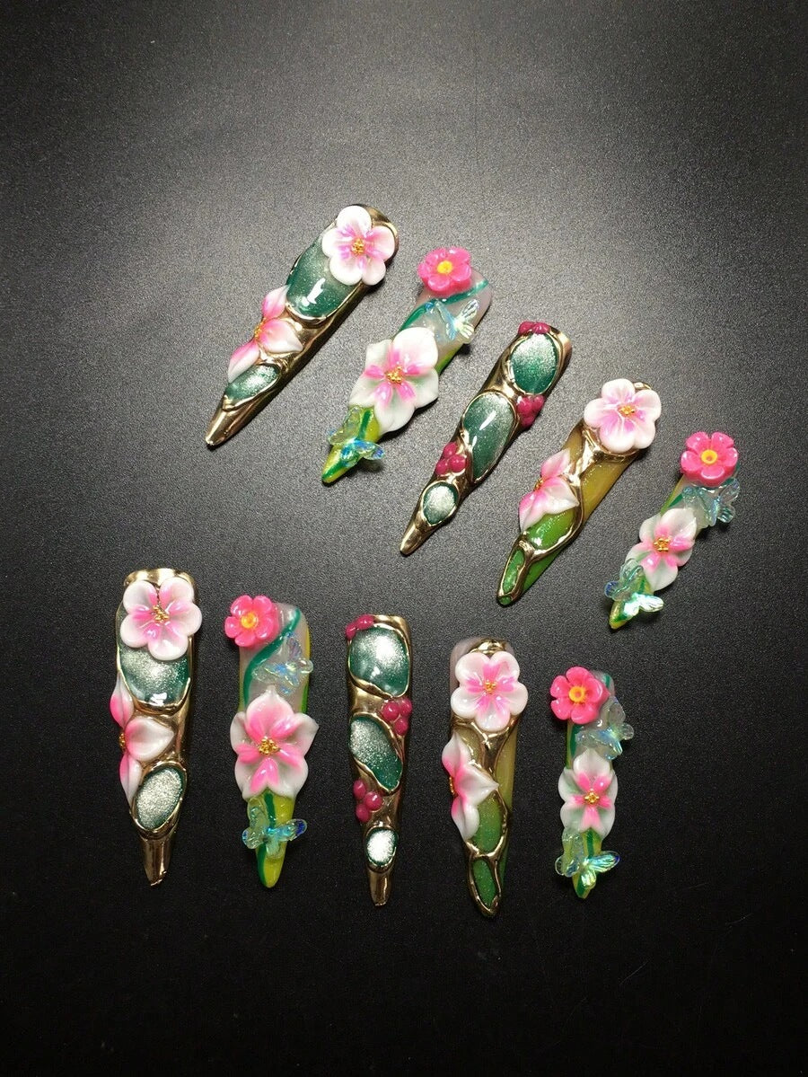 Peony Parlor stiletto nails with gold edging and crystals