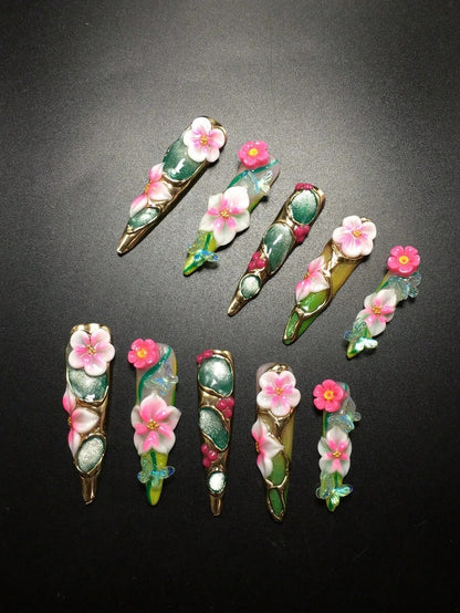 Peony Parlor stiletto nails with gold edging and crystals
