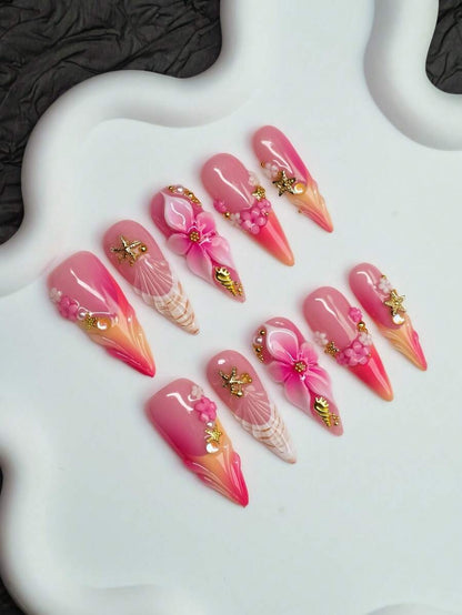 Sunset Shell almond nails fanned out with sculpted flowers and shell art