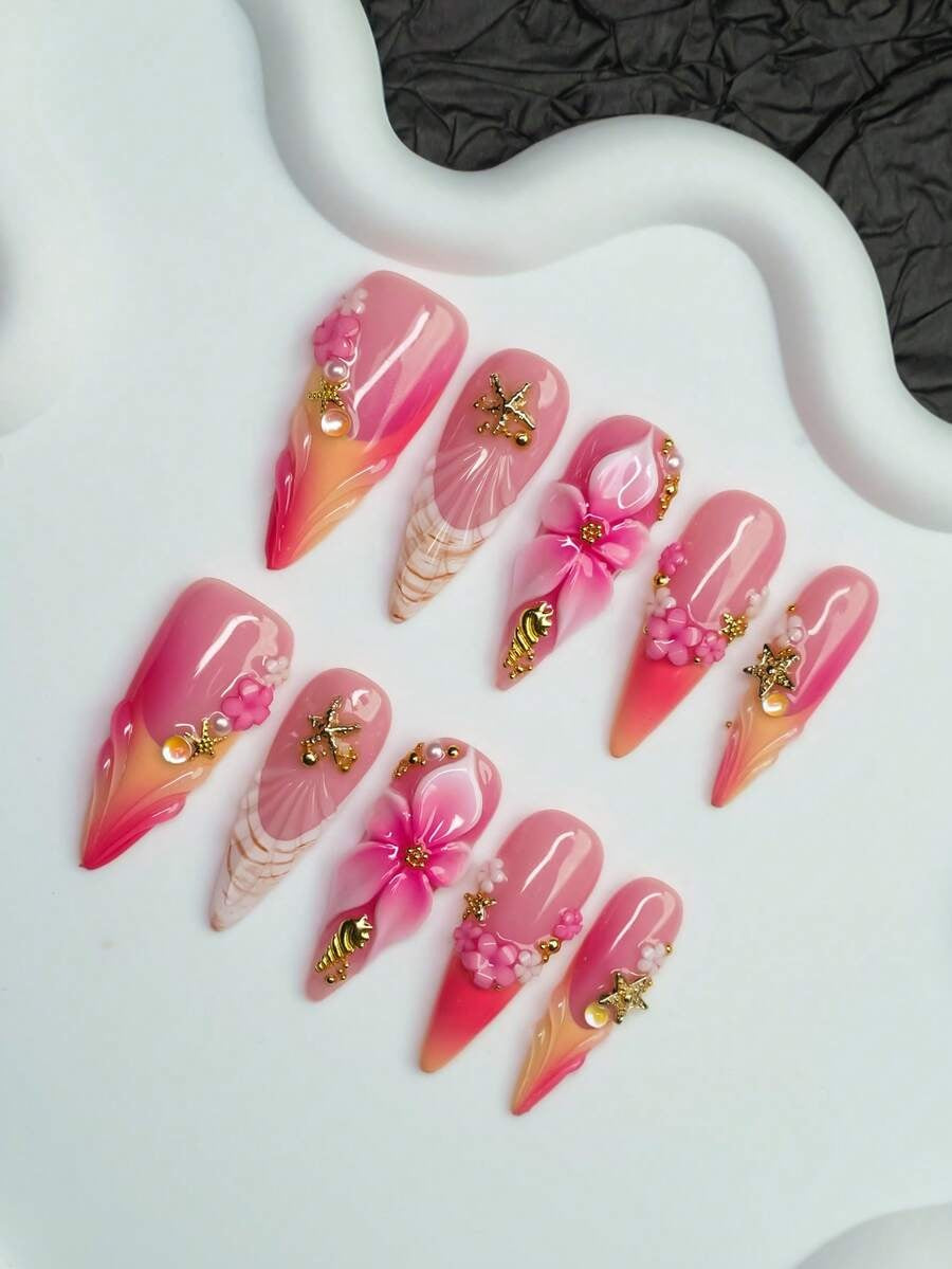 Sunset Shell almond nails with gold charms and pearl beads