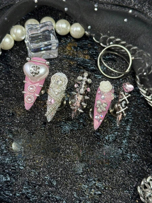 Sweet Sinner long stiletto press on nails in pink, white and black with silver crosses and a pearl heart